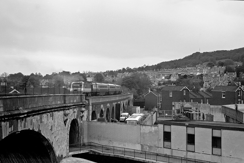 Class 43, unidentified up working, Dolemaeds Viaduct 
 An unidentified class 43 HST leaves Bath with a working for London Paddington. It is crossing the Dolemeads viaduct with some of Bath's world renowned architecture clearly visible on the hills above the city in the background. I for one am thankful that the government's decision to halt the GWML's electrification 'indefinitely' in July 2017 meant that this scene, essentially the same as when this picture was taken, will remain the same and not be blighted by the electrification infrastructure. 
 Keywords: Class 43 up working Dolemaeds Viaduct