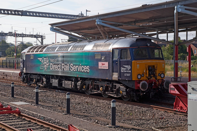 57307, stabled Thunderbird, Rugby station 
 57307 'Lady Penelope' sits in one of Rugby's up facing bay platforms waiting for that 'phone call! It was once of the famous Virgin red Thunderbirds but the work has now been contracted to DRS. The original but now very faded Virgin nameplate is till affixed to the side of the class 57 as a reminder of its past. 
 Keywords: 57307 Thunderbird Rugby station