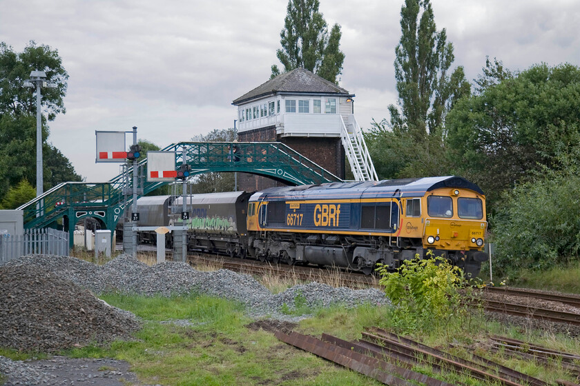 66717, 13.58 Tyne Dock-Drax, Billingham crossing 
 66717 Good Old Boy leads the 6H32 13.58 Tyne Dock to Drax power station train past the impressive Billingham signal box passing under the characteristic North Eastern Railway footbridge. It is likely that the wagons are carrying imported biomass that is now fuelling Drax power station, in part at least. I do not know the reporting number of this particular working unless anybody can advise. 
 Keywords: 66717 13.58 Tyne Dock-Drax Billingham crossing GBRF GB Railfreight Good Old Boy