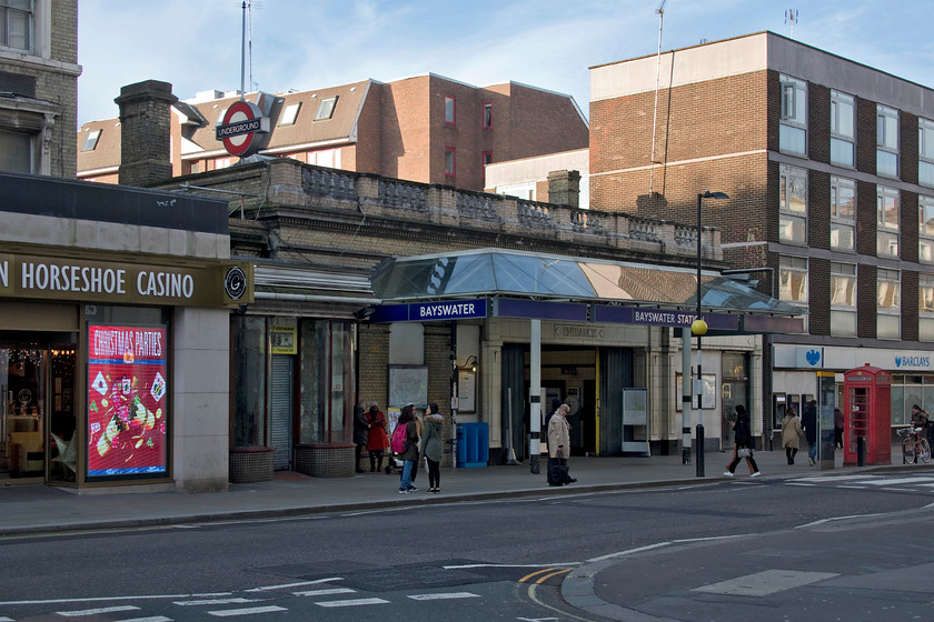 Frontage, Bayswater LU station 
 Located on the busy Queensway, Bayswater tube station serves the Circle and District lines. It was constructed by the steam-operated Metropolitan Railway (MR) and opened in 1868. The line is close to the surface and was constructed using the cut and cover method with the platforms at Bayswater open but covered by a roof. 
 Keywords: Frontage Bayswater LU station