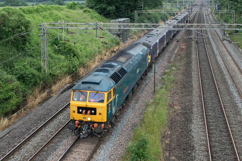 47749 & 360108, 08.22 Cricklewood Depot-Northampton EMD (5Q97, 14E), Victoria bridge 
 From Victoria bridge just south of Roade 37611 'Pegasus' heads south in the distance as the 0H73 light engine move from Derby to Wembley. Meanwhile 47749 'City of Truro' leads an East Midlands Desiro 360108 to Northampton as the 5Q97 08.22 Cricklewood to Northampton EMD presumably for an exam of some kind? With the Class 360s now in service on the MML between St. Pancras and Corby they still need to be maintained and it is Siemens' Kingsheath depot that will be undertaking this work. Whilst it is good news that GBRf has got the contract to haul them from their Cricklewood base I do not quite understand why arrangements have not been made for them to run under their own power? Just a thought to finish on: with the Class 47 being fifty-six years old and the Class 37 in the distance approaching its sixtieth the combined age of the two veteran locomotives is over one hundred and fifteen years old! 
 Keywords: 47749 360108 08.22 Cricklewood Depot-Northampton EMD 5Q97 Victoria bridge City of Truro