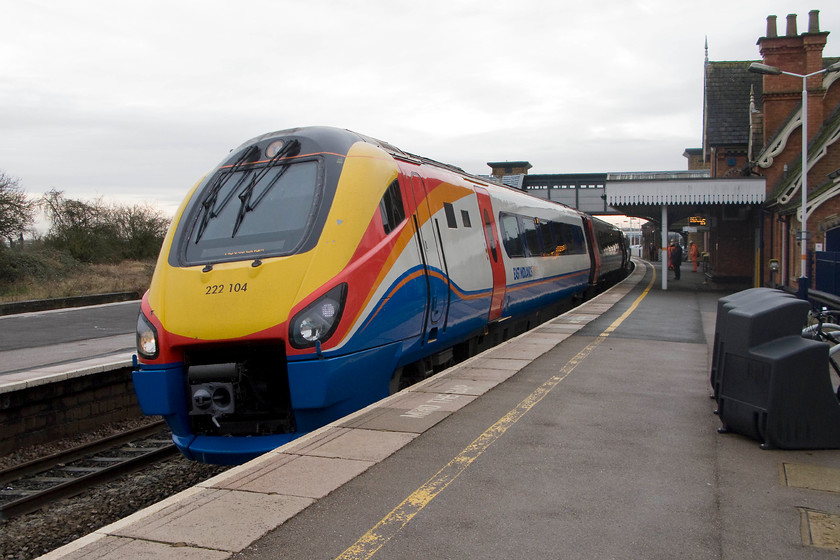 222104, EM 10.29 London St. Pancras-Nottingham (1D24), Wellingborough station 
 221105 passes through Wellingborough station at line speed forming the 10.29 St. Pancras to Nottingham service. This photograph is not tipped but shows clearly the camber of both the track and the slope away from the track of down platform at Wellingborough. The latter was a late addition following the disastrous accident where seven people were killed on 2nd September 1898 when the 19.15 St. Pancras to Manchester was derailed after hitting a luggage trolley that had run off the platform on to the track. One of the chief findings of the Board of Trade enquiry was that platforms should slope away from running lines, something that is still done today. 
 Keywords: 222104 10.29 London St. Pancras-Nottingham 1D24 Wellingborough station