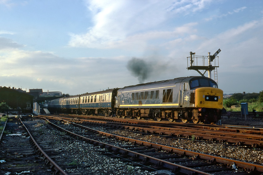 45121, 17.30 Sheffield-London St. Pancras, Wellingborough Junction 
 In the perfect evening light, 45121 gets away from Wellingborough station with the 17.30 Sheffield to London St. Pancras stopper. The low light illuminating the bulk of the Peak picks out its 1Co-1Co wheel arrangement carrying their rather overweight one hundred and thirty-three tons. As can be seen, Graham and I are in a rather exposed position right opposite Wellingborough Junction signal box but the signalman seemed unperturbed by our presence. 
 Keywords: 45121 17.30 Sheffield-London St. Pancras Wellingborough Junction