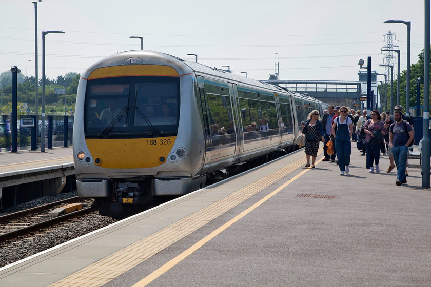 168325, CH 13.11 Oxford-London Marylebone (1Y29, 4L), Oxford Parkway station 
 On a day of full dull the sun chooses to come out just when I didn't want it to! 168325 comes to a halt at Oxford Parkway station forming the 13.11 Oxford to London Marylebone. I took this train the short distance to Bicester Town/Village station to meet my wife and son who had been hard spending money! The quality of the ride on the newly laid track was very good, the 165 was suitably quiet and I think that this new route will prove to be a great success. 
 Keywords: 168325 1Y29 Oxford Parkway station