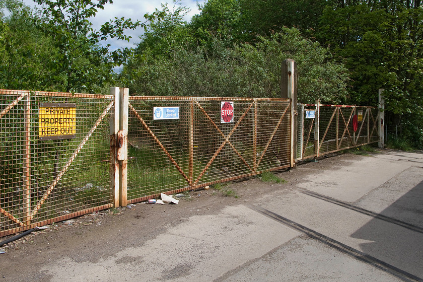 Former level crossing gates & track, Forge Lane, Horbury Junction 
 There were a number of tracks that led into the former Horbury railway works that closed in 2005 with the extensive site now in use by a number of companies. Whilst the works was best known for it manufacture, overhaul and maintenance of wagons it was also involved, during World War II, in the manufacturing of the Churchill tank. When Procor bought the operations, the plant produced bodyshells for the BR class 60 and when Bombardier took over it built class 92 bodyshells. Just before closure in the early 2000s it completed extensive overhauls on GNER's Mk. IV stock. Strange to think that rakes of smart blue GNER Mk. IV coaches will have rolled past this spot! 
 Keywords: Former level crossing gates track Forge Lane Horbury Junction