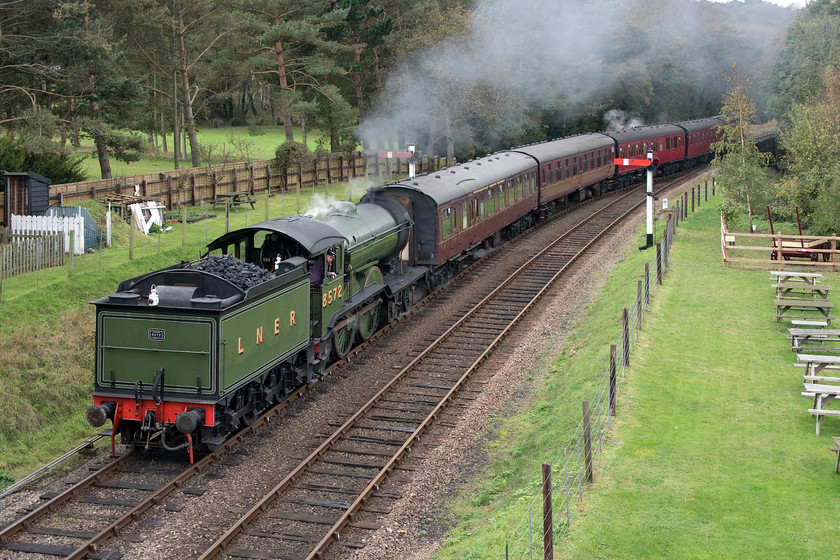 8572, 10.40 Holt-Sheringham, Weybourne station 
 Having seen 8572 lead the outward working a little earlier it is seen now running tender first into Weybourne station with the 10.40 Holt to Sheringham. As can be seen here it is running into the 'wrong' platform in order to facilitate an easier token exchange as Weybourne station was closed as part of the heritage line's COVID management. As well as the closure of the station there were severe restrictions on travelling arrangements with just return journeys possible and in groups of no more than six family members to a compartment in the three former suburban stock seen at the rear of this train. In addition to these travelling arrangements, no access was permitted to either Holt or Sheringham stations unless travelling on one of its later return workings throughout the day. 
 Keywords: 8572 10.40 Holt-Sheringham Weybourne station LNER B12