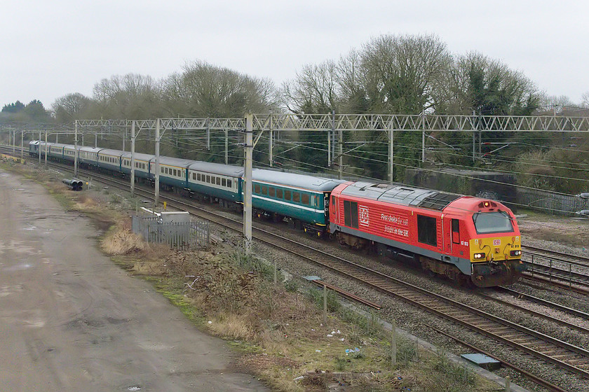 67013, outward leg of The Robert Burns, UKR, 08.10 London Euston-York (1Z72, RT), site of Roade station 
 With just one former Greater Anglia liveried Mk.II coach spoiling the uniform rake of stock, the outward leg of 'The Robert Burns' charter passes the site of Roade station. The train left Euston at 08.10 and is being led by DB liveried 67013 that certainly brightens up a very dull morning. The charter reached York just after 14.00 leaving only two and a half hours later. This gave the passengers very little time to explore the city let alone to spend an adequate amount of time in the National Railway Museum! 
 Keywords: 67013 The Robert Burns 1Z72 site of Roade station UKR UK Railtours 08.10 London Euston-York