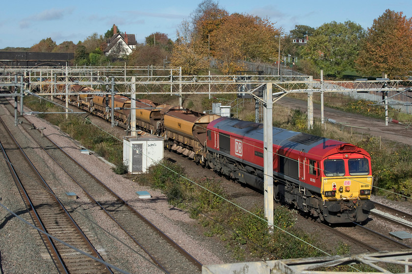 66055, 11.00 Denbigh Hall South-Bescot Engineers (6G54, 3E), site of Roade station 
 Having been involved in an overnight possession 66055 'Alain Thauvette' is seen dead in tow at the rear of the 11.00 Denbigh Hall to Bescot empty ballast train. The HQA autoballasters were all empty having discharged their load in the Milton Keynes area over the previous night. The train is seen passing the site of Roade's former station. 
 Keywords: 66055, 11.00 Denbigh Hall South-Bescot Engineers (6G54, 3E), site of Roade stationAlain Thauvette HQA autoballaster