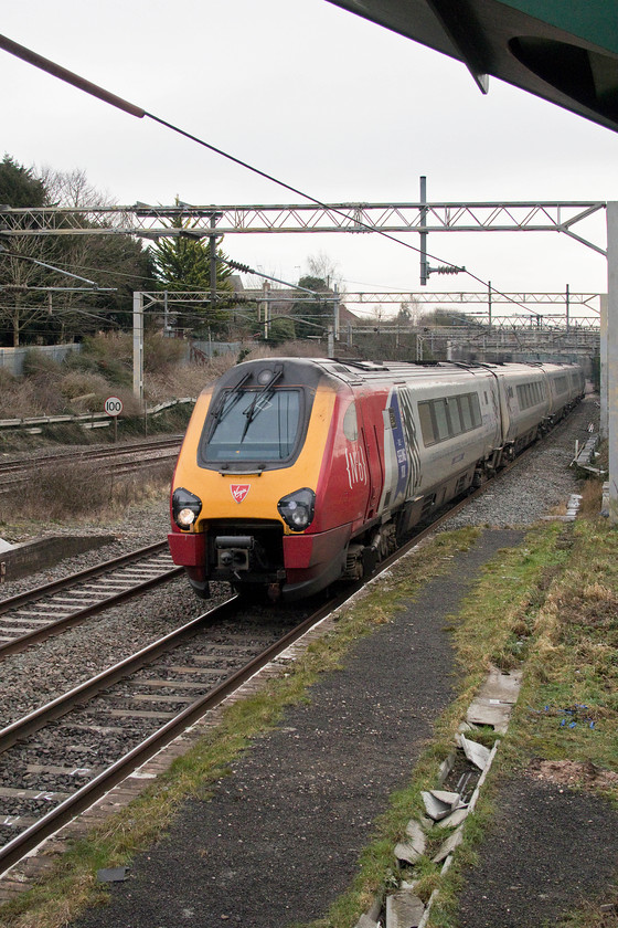 221106, VT 12.43 London Euston-Edinburgh (9S70, 1E), site of Castlethorpe station 
 221106 'Willem Barents' is about to pass under Castlethorpe's footbridge working the 12.43 Euston to Edinburgh (9S70). I've said it before, and I'll say it again, where's the sense in running a diesel unit for 400 miles all the way to Edinburgh under 25kV catenary? If anybody from Virgin's train planning department ever reads my ramblings, please let me know! 
 Keywords: 221106 12.43 London Euston-Edinburgh 9S70 site of Castlethorpe station