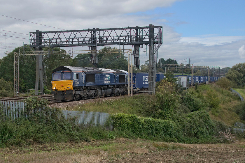 66305, 13.09 DIRFT-Ripple Lane (4L48, 10L), Roade Hill 
 66305 is not one of my most photographed DRS Class 66s and on this day it was making a very strange noise as it toiled past me between Roade and Ashton leading the daily 4L48 Daventry to Purfleet that, as is usual on a Sunday, terminates at Ripple Lane. As the locomotive passed me the driver gave me a cheery wave from the open cab window so he was obviously not too concerned about the odd-sounding engine and it arrived just ten minutes late - so it must be me! 
 Keywords: 66305 13.09 DIRFT-Ripple Lane 4L48 Roade Hill DRS Direct Rail Services