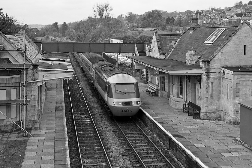 253019, unidentified diverted up working, Bradford-on-Avon station 
 I took very few photographs from Bradford-on-Avon's Frome Road bridge preferring the station platforms and the footbridge. I think that I understand why as the images from this position feel a little cramped but they certainly offer a different perspective of the delightful little station buildings. The disused down platform building is undergoing some restoration that looks as though it includes a new roof and attention to the canopy. HST set 253019 (either 43038 or 43039) is seen passing through with an unidentified up working for Paddington diverted off its normal GWML route. 
 Keywords: 253019 diverted up working Bradford-on-Avon station HST Frome Road