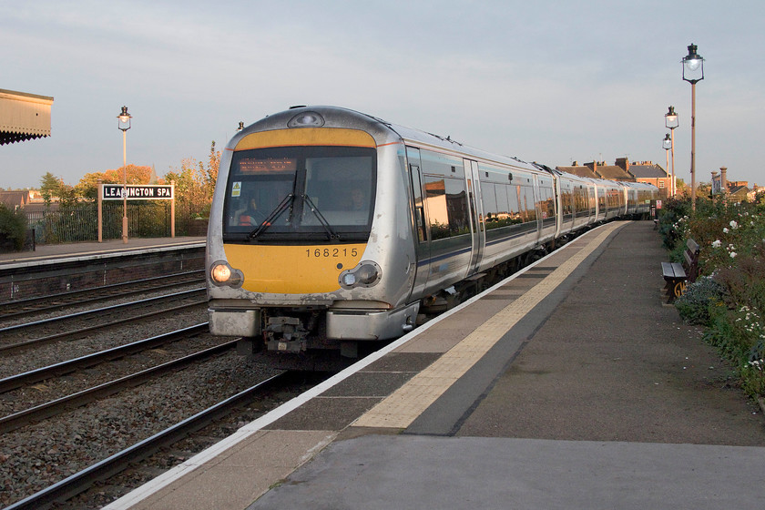 168215, CH 14.40 London Marylebone-Birmingham Snow Hill (1G39, 3L), Leamington Spa station 
 In the dying afternoon light, added to by some welcome late sunshine, 168215 arrives at Leamington Spa station forming the 14.40 Marylebone to Birmingham Snow Hill service. The radical and smart silver livery applied to the Chiltern stock a few years ago is looking a little jaded, at least on the front of this particular unit. Also, notice the superbly well-kept garden to the right of this image. Leamington is a lovely station that is very well kept; if only all stations were like this! 
 Keywords: 168215 14.40 London Marylebone-Birmingham Snow Hill 1G39 Leamington Spa station