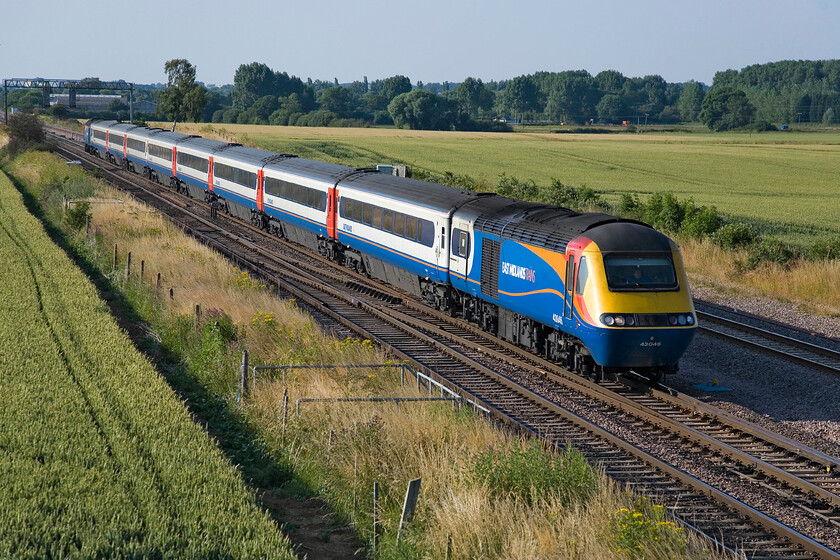 43046, EM 17.28 Nottingham-London St. Pancras, Harrowden Junction 
 I feel that the East Midlands Trains livery applied to the elderly HSTs really suits them and is far better than the dull FGW paint scheme applied to the ones operating in and out of Paddington. Leading, 43046 makes a fine sight as the 17.28 Nottingham to St. Pancras service passes Harrowden Junction. As a fare-paying passenger, I would infinitely prefer making this journey in a Mk. III coach rather than on-board a Meridian with their underfloor engines spoiling the ambience. 
 Keywords: 43046 17.28 Nottingham-London St. Pancras Harrowden Junction EMT HST East Midlands Trains