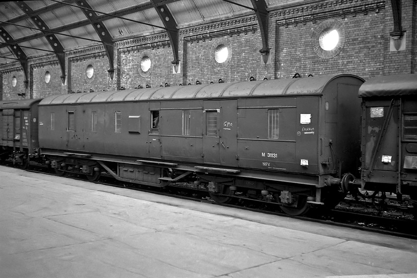 S1414, M31131 & S1311, Darlington station 
 Whilst the LMS van is not far from home the two Southern vans attached at either end of it are! Even in 1980, there were many vans still in use for the conveyance of parcel traffic that was very much in decline by this time. This NFV former LMS designed vans were once extremely numerous but many were being scrapped by the early 1980s. M31131 was Derby built and dated from 1940 but I do not have the lot number but from the number, I know that it was a series three version of the design. Notice that in common with most of these vans by this time, the end connecting doors had been plated over. The two former Southern vans pre-date the LMS variant being built at Ashford in 1939. S1414 and S1311 were two of a batch of one hundred and forty-eight vehicles designated by the Southern as 1303s. These three vans were part of parcels consist that was obviously loaded given the white labels under the spring clips on the sides. 
 Keywords: S1414 M31131 S1311 Darlington station