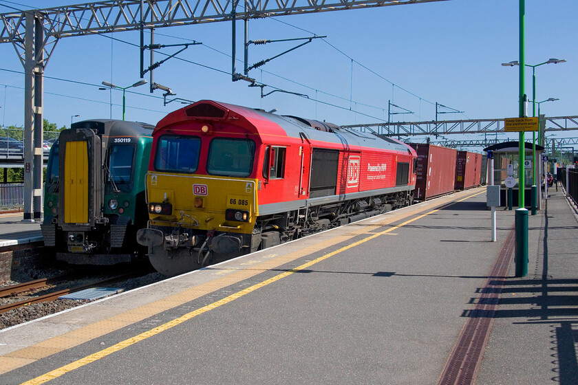 350119, LN 15.15 Tring-London Euston (2T44, 4L) & 66085, 09.51 Southampton Western Docks-Birch Coppice (4M71, 70L), Tring station 
 66805 rushes through Tring station with the diverted 4M71 09.51 Southampton Western Docks to Birch Coppice service. With the repairs to the Nuneham viaduct embankment (not the viaduct itself as is often reported) coming to a close, these services will soon return to their normal route via the GW line through Leamington, Banbury and Oxford to Didcot. Adjacent to the northbound freight is 350119 which is waiting to leave the station as the 2T44 all-stations stopper service to Euston. 
 Keywords: 350119 15.15 Tring-London Euston 2T44 66085 09.51 Southampton Western Docks-Birch Coppice 4M71 Tring station London Northwestern Desiro DB