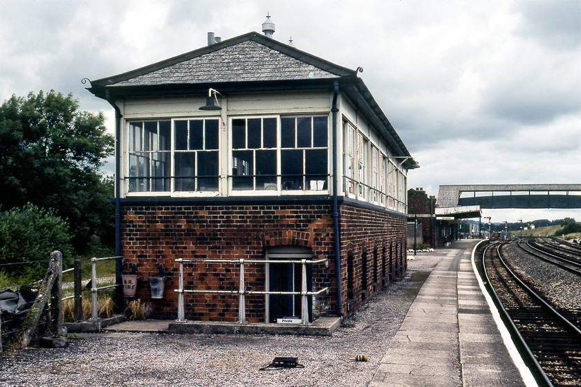 Tiverton Junction signal box (GW, 1932) 
 Tiverton Junction signal box is seen located on the western end of the up platform of the station of the same name. The box was a Great Western structure opened in 1932 when the lines through the station were quadrupled replacing an earlier box that I can find nothing out about - any information would be appreciated. Notice my new Sony TC-525 cassette recorder and foam wrapped Sony F-99A microphone on the platform. This was their first trip out to the lineside having just been purchased but, unfortunately, the recordings were for some reason deemed substandard and not kept according to my contemporary notes. 
 Keywords: Tiverton Junction signal box