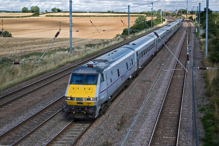 82206, GR 06.55 Edinburgh Waverley-London King's Cross (1E04), Swayfield SK99423 
 Just missing the sun that is warming the recently harvested wheat fields in the background the 06.55 Edinburgh to King's Cross passes Swayfiled. Running a full-line speed down Stoke Bank DVT 82206 leads the East Coast set with the driver cooly wearing his Top Gun-style dark glasses! 
 Keywords: 82206 06.55 Edinburgh Waverley-London King's Cross 1E04 Swayfield SK99423 East Coast DVT