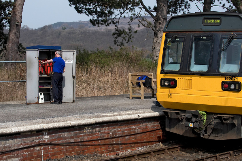 Exchanging the token, 142071, NT 11.58 Whitby-Hexham (2W35, 3L), Battersby station 
 Absolute block is still up and running on the Esk Valley, but not the traditional form! The driver of 142071, that is working the 11.58 Whitby to Hexham, has un-locked and opened the tablet cabinet on Battersby station. Under the authority of the signalmen at Nunthorpe, he is exchanging the tablet in the familiar equipment that is painted red. This system of working is known as No Signalman Token Remote and is in use on a small number of long and relatively sparsely used lines. Despite all of the modern technology available to us and the railways, it's warming to see a physical system in place and working well based on a principle that is well over one hundred years old! 
 Keywords: Exchanging the token 142071 11.58 Whitby-Hexham 2W35 Battersby station