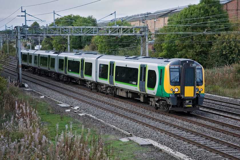 350261, LM 15.02 Crewe-London Euston, Roade 
 Running on the up fast line past Roade the 15.02 Crewe to Euston service is seen worked by 350261. These trains run as all station stopper services in the first part of their journey from Crewe becoming fast from Rugby non-stop to London. 
 Keywords: 350261 15.02 Crewe-London Euston Roade London Midland Desiro