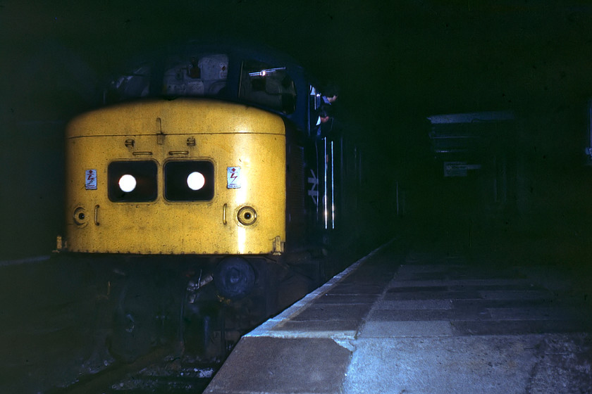 45035 & 46028 (DIT), West Wilts District Scouts Special, York-Westbury (1Z40), Bradford-on-Avon station 
 The secondman and the driver peer through the blackness at Bradford-on-Avon station looking for the guard's signal to get away. Peak 45035 is leading the returning West Wiltshire Scouts train cruise back from York that will soon reach its destination at Westbury with one more stop at Trowbridge. Out of sight behind the Class 45 is 46028 that disgraced itself at Bordesley Junction earlier in the journey. Against the present-day rules for railway enthusiasts, see.... https://www.networkrail.co.uk/communities/railway-enthusiasts/guidelines-for-taking-photos-at-stations/ I have used a flash to illuminate the dark scene as there appears to be no lighting on the station whatsoever. 
 Keywords: 45035 46028 West Wilts District Scouts Special, York-Westbury 1Z40 Bradford-on-Avon station Peak