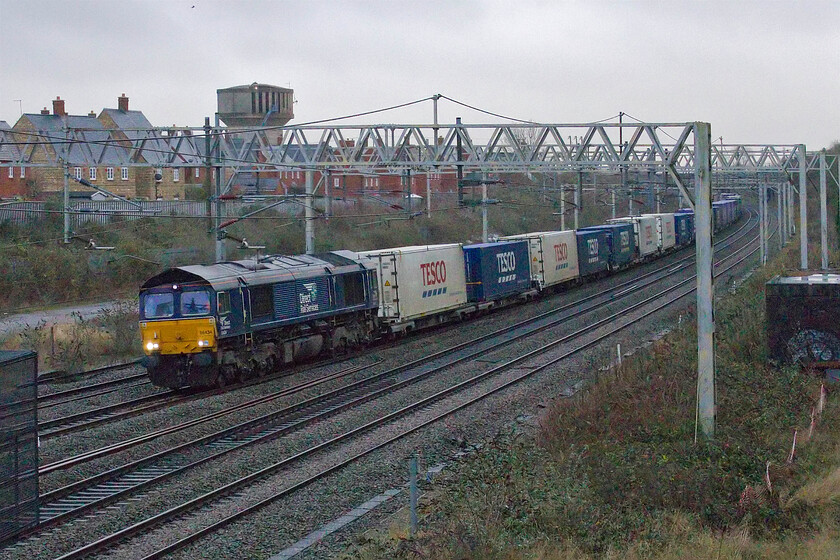 66434, 08.02 Tilbury Docks-DIRFT (4M07, 2L), site of Roade station 
 In really poor afternoon lighting with the drizzle starting once again 66434 leads the daily 4M07 Tesco Express through Roade. The 08.02 Tilbury to DIRFT runs seven days per week as does the 4L48 return working both operated by GBRf. 
 Keywords: 66434 08.02 Tilbury Docks-DIRFT 4M07 site of Roade station Tesco Express GBRf