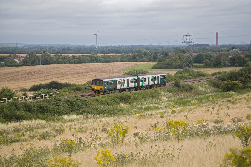 150137, LN 08.47 Bedford-Bletchley (2S06, RT), Lidlington SP978384 
 Seen from a field above Marston Vale 150137 works the 08.47 Bedford to Bletchley London Northwestern service. The train has just left Lidlington station located about half a mile to the right. In previous years this scene would have been dominated by many chimneys associated with the brick industry that dominated Marston Vale centred on Stewertby. That industry has all gone with us relying on imported bricks with the only chimney seen now being part of the highly controversial Covanta Incinerator. 
 Keywords: 150137 08.47 Bedford-Bletchley 2S06 Lidlington SP978384 London Northwestern