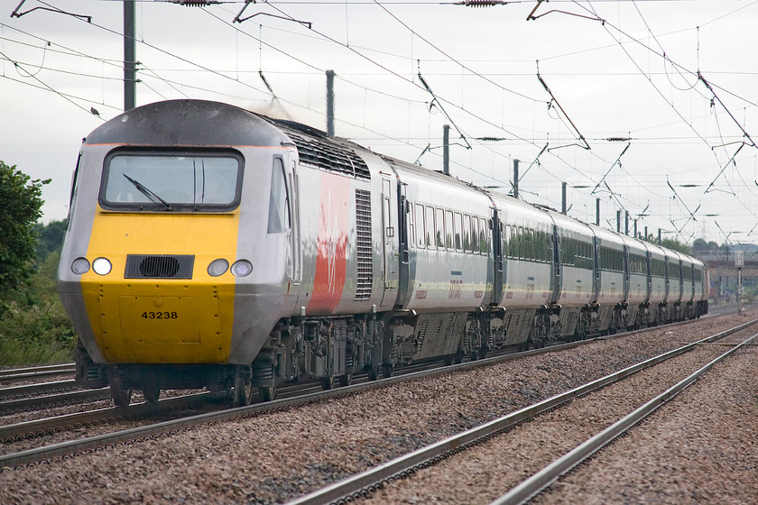 43238, GR 07.30 Lincoln-London KIng`s Cross (1B81), Holme Green crossing TL192426 
 HST power car 43238 leads the 07.30 Lincoln to King's Cross Virgin East Coast service past Holme Green crossing between Biggleswade and Arlesey. This power car, as 43038, was an early Western Region delivery being part of set 253019 that I photographed a number of times as a boy in the West Country, for example, see.... https://www.ontheupfast.com/v/photos/21936chg/26402385404/x253019-down-working-bathampton-st769662 
 Keywords: 43238 07.30 Lincoln-London KIng`s Cross 1B81 Holme Green crossing TL192426Virgin East Coast HST Biggleswade Arlesey