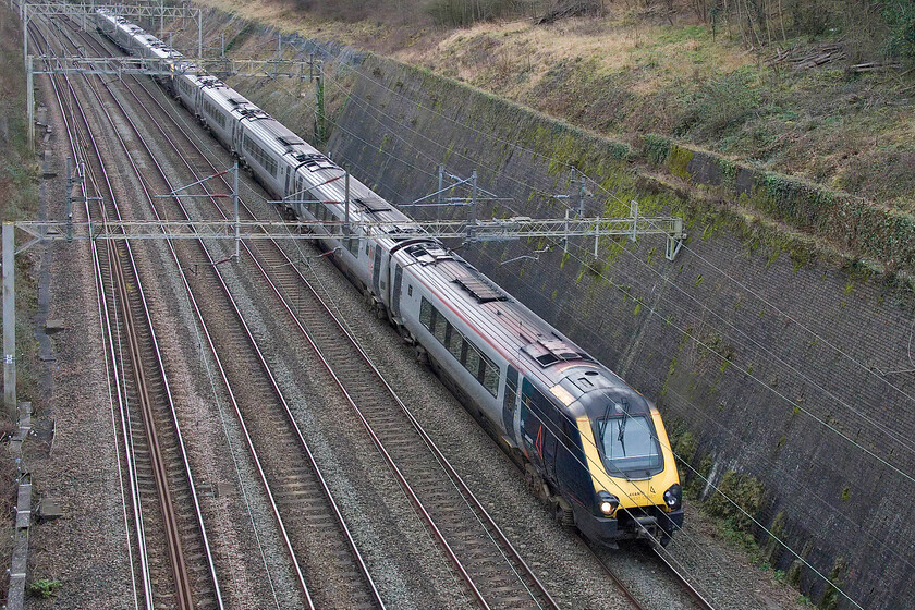 221118 & 221102, VT 13.02 London Euston-Holyhead (1D87, RT), Roade cutting 
 Will they make it through to 2024; with just a week to go, I suspect that they will! 221118 leads 221102 through Roade cutting taken from Bridge 209 known locally as Dirty or Muddy Lane bridge. Technically this is now the fourth crossing of the cutting from the north with the addition of the A508 bypass bridge (Bridge 209B?) from which photographs are all but impossible without a suitable ladder of some kind. Of course, there is also the aqueduct (Bridge 209A) but anybody climbing on that with their camera would be in serious danger! 
 Keywords: 221118 221102 13.02 London Euston-Holyhead 1D87 Roade cutting AWC Avanti Voyager