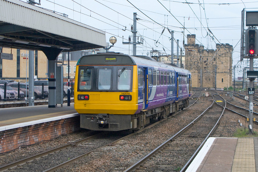 142016, NT 16.02 Metrocentre-Morpeth (2A26), Newcastle station 
 142016 trundles out of Newcastle Central station with the 16.02 Metrocentre to Morpeth service. The Pacer is heading towards the grade I listed and scheduled ancient monument known as The Keep, a remaining part of Newcastle Castle. As well as a visitor attraction, The Keep has also been a favourite haunt for railway enthusiasts as it provides a superb elevated view of the station from the east. 
 Keywords: 142016 16.02 Metrocentre-Morpeth 2A26 Newcastle station pacr northern trains