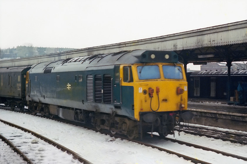 50003, up parcels working, Bristol Temple Meads station 
 50003 takes the centre road through Bristol Temple Meads with an unidentified up parcels working. Due to the inclement weather, there were a number of odd workings and this was another example. Class 50s on parcel workings were not common so I suspect that the loco. was called on due to the unavailability of a suitable class 47 or 31. 
 Keywords: 50003 up parcels working Bristol Temple Meads station