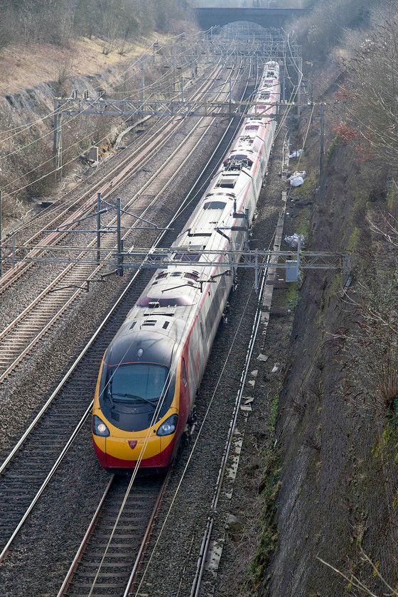 390001, VT 11.20 London Euston-Manchester (1H07, RT), Roade Cutting 
 390001 'Virgin Pioneer' sweeps through Roade Cutting forming the 1H07 11.20 London Euston to Manchester Piccadilly. As Roade Cutting runs approximately North-South some photographic rules have to broken to capture down trains, particularly, like this one, when taken in the winter months! 
 Keywords: 390001 1H07 Roade Cutting