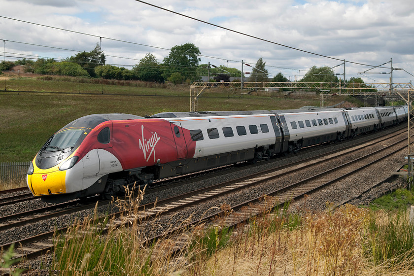 390049, VT 11.35 Manchester Piccadilly-London Euston (1A29, 4E), Old Linslade 
 390049 leans into the sharp curve at Old Linslade forming the 11.35 Manchester Piccadilly to London Euston. A small patch of half-sun has just illuminated the subject but this only goes to illustrate that I Andy and I are on the wrong side of the line at this particular spot at this time in the day! 
 Keywords: 390049 1A29 Old Linslade