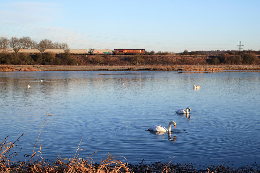 66069, 07.07 Mountsorrel-Radlett (6C31), Nene Valley SP913670 
 The swans seen totally unruffled by the passage of the 07.07 Mountsorrel to Radlett stone train as it passes them with 66069 leading. This early morning 6C31 freight is about to cross the Fourteen Arches viaduct as it is known locally to the people of Wellingborough. 
 Keywords: 66069 07.07 Mountsorrel-Radlett 6C31 Nene Valley SP913670