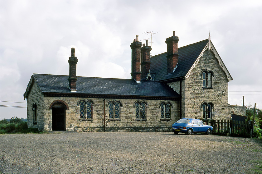 Frontage, former Glendon & Rushton station (Closed 04.01.60) 
 The rather grand former Glendon and Rushton station stands next to the double-tracked Midland Mainline. The station was opened in 1857 as Rushton station but was renamed in 1896 so as to avoid confusion with the nearby Rushden station that is actually pronounced 'Rush-ten' (sic) by Northamtoniaons. The station was closed on 04.01.60 with the house becoming a private residence in later years after restoration and is now a Grade II listed structure. It looks as though the owner of the Austin Allegro parked in front of the station needs to get one side of the Hydrogas suspension pumped up! 
 Keywords: Frontage former Glendon & Rushton station