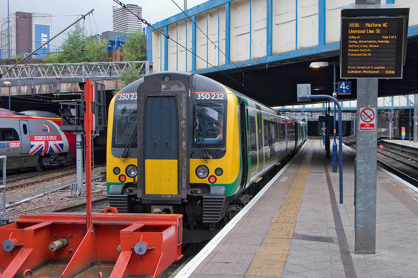 350232, LM 10.36 Birmingham New Street-Liverpool Lime Street (1F39), Birmingham New Street station 
 With eight minutes until its departure, the guard of the 10.36 Birmingham New Street to Liverpool Lime Street takes a little time as he sits in the rear cab of 350232 prior to its departure. Meanwhile, 390151 with its one-off 'Business is Great' vinyls waits at a nearby platform. My wife and I took the London Midland Desiro all the way to Liverpool. 
 Keywords: 350232 10.36 Birmingham New Street-Liverpool Lime Street 1F39 Birmingham New Street station London MIdland Desiro