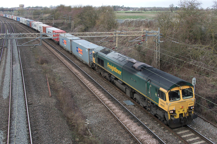 66501, 05.00 Trafford Park-Felixstowe North (4L97), Victoria bridge 
 The long and well loaded 4L97 05.00 Trafford Park yo Felixstowe Freightliner passes Victoria bridge between Roade an Wolverton on the WCML. It is led by 66501 'Japan 2001' a member of the class that was named early on its career in, not surprisingly, 2001! 
 Keywords: 66501 05.00 Trafford Park-Felixstowe North 4L97 Victoria bridge