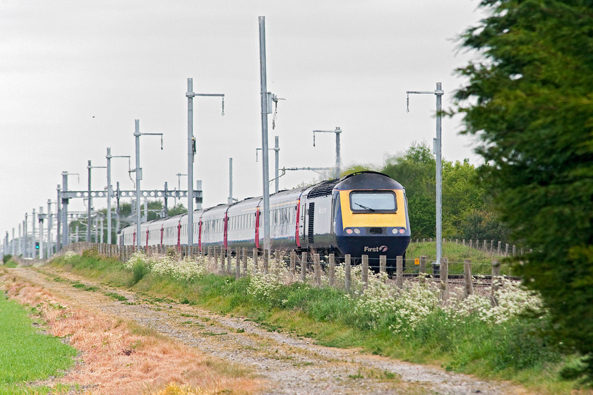 43170, GW 13.45 London Paddington-Swansea (1B40, 4L), Steventon 
 43170 heads westwards at the rear of the 13.45 Paddington to Swansea. I wonder what Brunel would have thought about the desecration of his fantastically designed and constructed GWML. The 'hard engineered' electrification paraphernalia does not enhance the scene here at Steventon or anywhere for that matter. 
 Keywords: 43170 1B40 Steventon