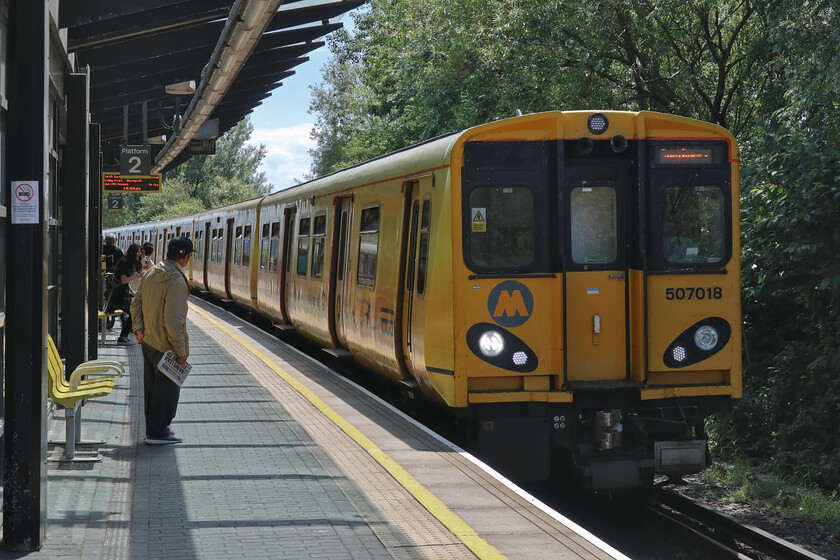 507018, ME 14.21 Hunts Cross-Southport (2S34, RT), Sandhills station 
 Our hunt for an operational Merseyrail Class 507 was successful on arrival back at Sandhills. Whilst using a vending machine in the waiting room this unit rolled in so Andy managed a cool drink whilst there was no time for me to get mine with a trip aboard 507018 trumping it! We travelled on the 14.21 Hunts Cross to Southport service from here at Sandhills to its destination. The contrast between our journies on the Class 777s with this forty-five-year-old train was marked but were the new ones any better; I'm not so sure. 
 Keywords: 507018 14.21 Hunts Cross-Southport 2S34 Sandhills station Merseyrail