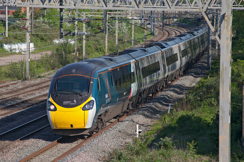 390124, VT 16.30 London Euston-Crewe (1F19, 1L), site of Roade station 
 It's astonishing to think that Pendolinos are twenty years old next year! Many first-generation diesels such as my beloved Westerns had been and gone in less time than this! As 390024 this particular example was one of the earlier members of the class that is now in the hands of its second operator Avanti West Coast. Now an eleven car set and numbered 390124 it is seen passing Roade in lovely late afternoon sun working the 1F19 16.30 Euston to Crewe service. 
 Keywords: 390124 16.30 London Euston-Crewe 1F19 site of Roade station Avanti West Coast Pendolino