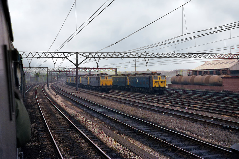 76014, 76004, 76041, 76001, 76051, 76040, 76047 & 76054, stabled, Guide Bridge 
 As it was a freight line, at weekends, there was little traffic over the Woodhead route with most of its unique 1500V class 76s lying idle. At the western end of the line in the eastern suburbs of Manchester they were kept in Guide Bridge yard as shown here. In an impressive and neat line-up no fewer than eight examples of the class are seen, 76014, 76004, 76041, 76001, 76051, 76040, 76047 and 76054. To a southern spotter like myself, this was 'cop heaven' as was much of what I recorded in my notebook on this particular day! 
 Keywords: 76014 76004 76041 76001 76051 76040 76047 76054 Guide Bridge