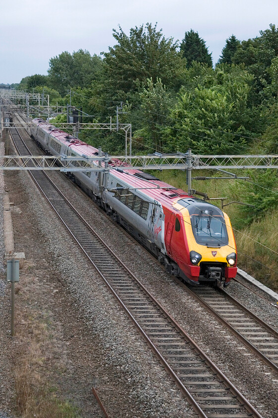 Class 221, VT 18.10 London Euston-Chester, Victoria bridge 
 An unidentified Class 221 Voyager speeds past Victoria bridge just south of Roade working Virgin's 18.10 Euston to Chester service. Unfortunately, recording the number of Voyagers is very tricky when they pass at speed due to the number being written very low down on the flank of the cab. 
 Keywords: Class 221 18.10 London Euston-Chester Victoria bridge Virgin West Coast Voyager