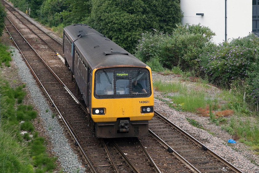 143621, GW 11.23 Exmouth-Paignton (2T13, 4E), Torbay Road footbridge, Paignton 
 I am sure that the rail users of South Devon are looking forward to when these early second generation DMUs come off-lease and out of service soon! Here, 143621 arrives at Paignton and is about to pass under Torbay Road footbridge and cross the level crossing with the 11.23 from Exmouth. I have not taken a picture from this classic location since the mid 1980s, then it was of Peaks, 47s and 50s interspersed with some first generation class 118 DMUs all passing an array of semaphores. 
 Keywords: 143621 2T13 Torbay Road footbridge Paignton