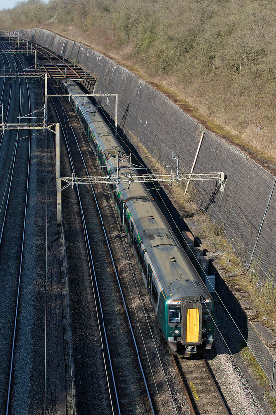 350404, 350263 & 350123, LN 13.55 Northampton-London Euston (2Z38, 8E), Roade cutting 
 The 2Z38 13.55 Northampton to Euston service emerges from the 'Birdcage' at the northern end of Roade cutting heading south. It has become clear that London Northwestern's emergency timetable trains (running mainly as 2ZXX) involves a fleet of three-set Desiros running between Euston and Northampton with very few through trains beyond to Birmingham. It is interesting that they are operating three-set trains rather than the more usual two-set ones when passenger numbers have haemorrhaged. I would like to think that it is so that passengers can sit in appropriately socially isolated positions! 
 Keywords: 350404 350263 350123 13.55 Northampton-London Euston 2Z38 Roade cutting London Northwestern Desiro