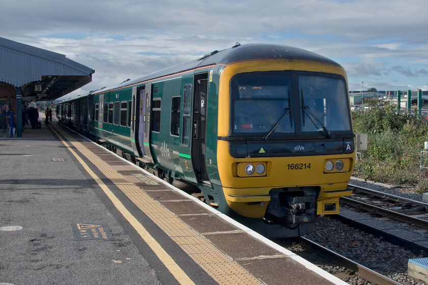 166214, GW 08.23 Portsmouth Harbour-Cardiff Central (Cancelled from Newport) (1F10, 60L), Westbury station 
 With a rapid crew change having just taken place at Westbury station 166214 will soon get underway again working the 1F10 Portsmouth Harbour to Cardiff Central service. Unfortunately, there will be a lot of fare repay claims from this service as it was already running fifty minutes late, a situation that did not improve with it being terminated at Newport now an hour adrift. 
 Keywords: 166214 08.23 Portsmouth Harbour-Cardiff Central 1F10 Westbury station GWR Great Western Railway