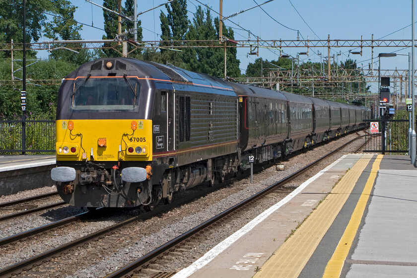 67005, Derby-Wolverton Centre Sidings Royal Train ECS, Northampton station 
 Movement of the Royal Train, be it when it is carrying members of the family or as ECS is never advertised so catching it is a little hit and miss unless you are in the know! It is seen passing through Northampton station on a Derby to Wolverton ECS move with 67005 'Queen's Messenger' leading the train. 
 Keywords: 67005 Derby-Wolverton Centre Sidings Royal Train ECS, Northampton station Queen's Messenger