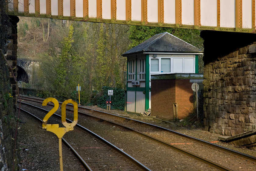 New Mills Central signal box (Midland, 1924) 
 In the early evening sunshine, New Mills Central signal box is seen from the platform end of the station. It was opened by the Midland in 1924 as it to their type 4d design. The railway, the track and the box itself cling to the side of the steep valley with the line having just emerged from the short New Mils tunnel that can be seen in the background. 
 Keywords: New Mills Central signal box