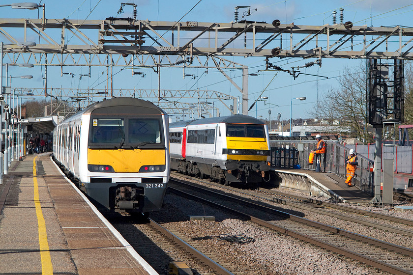 321343, LE 10.05 Clacton-on-Sea-London Liverpool Street (1N33) & 82133, LE 09.30 London Liverpool Street-Norwich (1P16), Colchester station 
 I stood and observed the two Network Rail workers on the platform end at Colchester for some time. I can honestly say that, apart from doing something on their mobile 'phones, they did precious little work! This is not an exception, I really do think that the efficiency with which the fabled 'orange army' work is very poor at times. A return to the favourite 1970s time and motion study would reveal some interesting facts; rant over! 321343 waits to leave with the 1N33 10.05 Clacton to Liverpool Street whilst DVT 82133 has come to a halt leading the 1P16 09.30 Liverpool Street to Norwich. 
 Keywords: 321343 10.05 Clacton-on-Sea-London Liverpool Street 1N33 82133 09.30 London Liverpool Street-Norwich 1P16 Colchester station