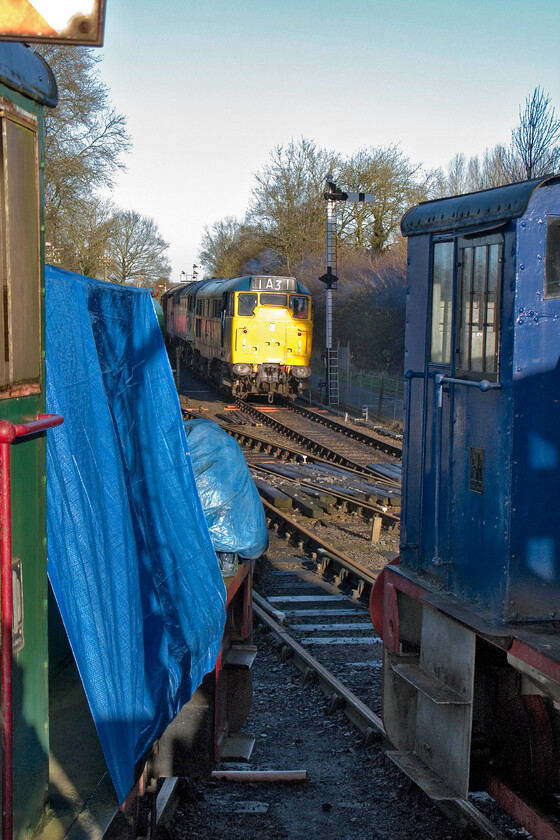 31289 & 47205, shunting stock into sidings, Pitsford & Brampton station 
 Viewed between the Northampton and Lamport Railway's two resident shunters 31289 propels 47205 and some vans back towards the sidings to the north of the station. This in order to clear the running line and to release the stock to be used on New Year's Day mince pie specials. 
 Keywords: 31289 47205 Pitsford & Brampton station