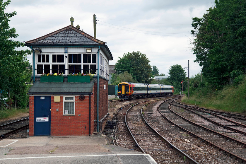 159104, SW 16.46 Yeovil Junction-London Waterloo (1O64, 2E), Yeovil Pen Mill station 
 159104 leaves Yeovil Pen Mill with the 16.46 Yeovil Junction to Waterloo (Via Castle Cary for Glastonbury Festival customers) is about to pass the only remaining lower quadrant signal, the up starter. In the foreground is the lovely GW Type 11 box, a late construction of this type dating from 1937. It is obvious that the staff maintain the traditions that signallers take care of their workplace with things like window box displays; I warrant that the inside was spick and span too! 
 Keywords: 159104, SW 16.46 Yeovil Junction-London Waterloo (1O64, 2E), Yeovil Pen Mill station