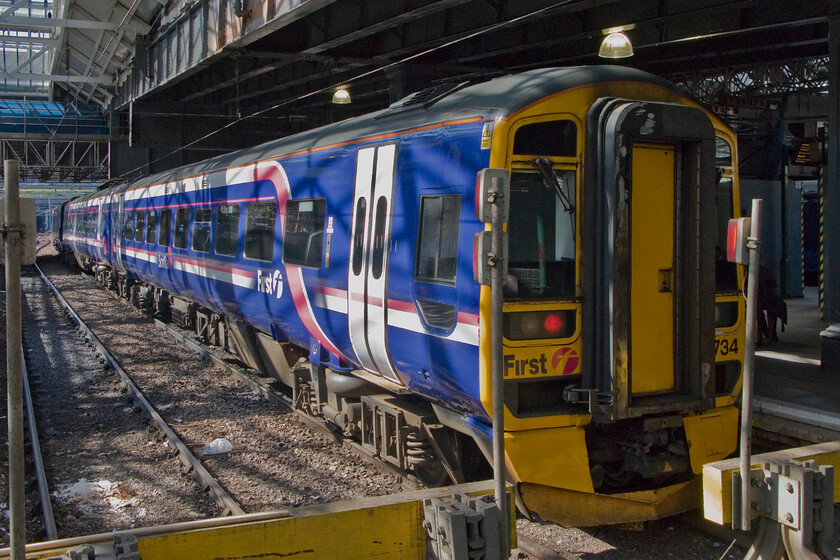 158734, SR 14.00 Edinburgh Waverley-Glasgow Queen Street, Edinburgh Waverley station 
 The new glazing installed in the roof of Edinburgh Waverley station has transformed the interior, particularly noticeable on bright days such as this with the quality of light being particularly intense. ScotRail's 158734 waits in one of the western-facing bay platforms with the 14.00 service to Glasgow Queen Street. 
 Keywords: 158734 14.00 Edinburgh Waverley-Glasgow Queen Street Edinburgh Waverley station ScotRail